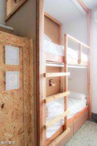 a couple of bunk beds in a room at Mayhow Donghe in Donghe