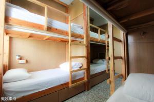 a bunk bed room with two bunk beds in it at Mayhow Donghe in Donghe