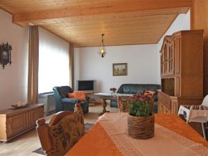 a living room with a table and a couch at Apartment in Sauerland with terrace in Helminghausen