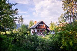 a small house in the middle of a forest at Chalet Ana Bohinj in Bohinj