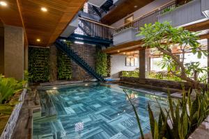 an indoor pool in a building with plants at Lahome Villa Apartment in Danang