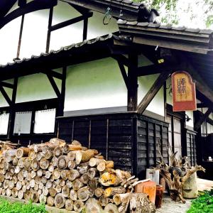 a pile of logs in front of a building at Villa yamato in Kumamoto