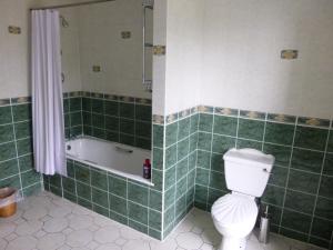 a bathroom with a tub and a toilet and a bath tub at Corbett Court in Fermoy