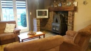 a living room with a couch and a fireplace at chez Françoise et Jean in Rochefort