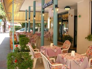 a restaurant with tables and chairs in a mall at Hotel Trovatore in Lido di Jesolo