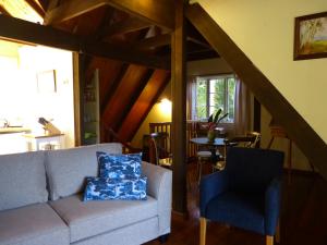 a living room with a couch and a chair at The Stables in Cooroy