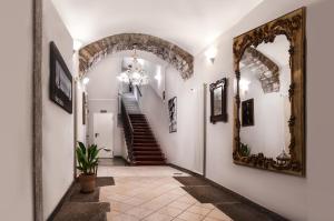 a hallway with a mirror and stairs in a house at Albergo Al Viale in Trieste