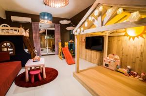 a childrens room with a bed and a play area at Happy B&B in Taitung City