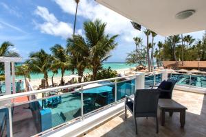 a balcony with a view of the beach and ocean at Hotel Checkin El Cortecito Beach in Punta Cana