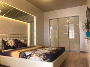 a bedroom with a king sized bed and a closet at Luxury Apartment in Downtown, Near River Esplanade in Kharkiv