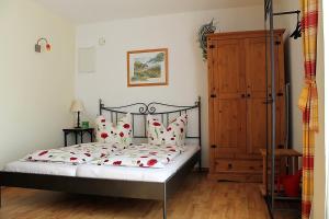 a bedroom with a bed with red flowers on it at Ostseehaus Prerow in Prerow