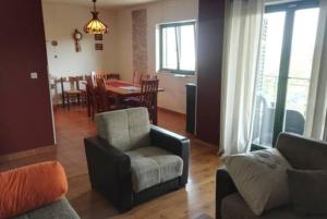 a living room with a couch and a chair and a table at Mirta in Kastel Novi