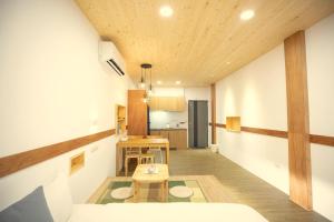 a living room with a table and a dining room at Lost Circle Homestay in Tainan