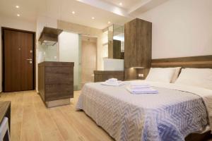 A bed or beds in a room at Electra & Myrto Apartments