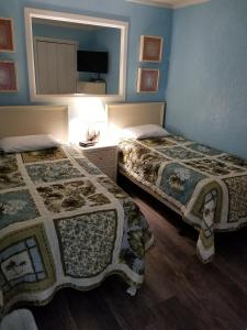 2 łóżka w pokoju z niebieskimi ścianami w obiekcie Myrtle Beach Resort- Unit A 428 w mieście Myrtle Beach