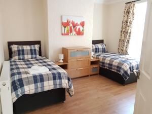 a bedroom with two beds and a tv in it at Central Location Preston 2 in Preston