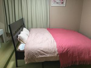 Postel nebo postele na pokoji v ubytování Kurosaki Guesthouse 403