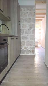 a kitchen with a stone wall and a stove at Nanna's little paradise in Hvar