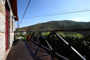 a wooden balcony with a view of a mountain at Casa do Lonho in Arouca
