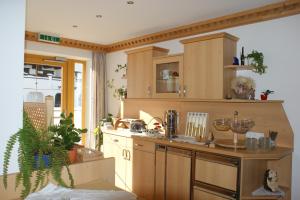 a kitchen with wooden cabinets and a counter top at Haus Bergkristall in Obergurgl