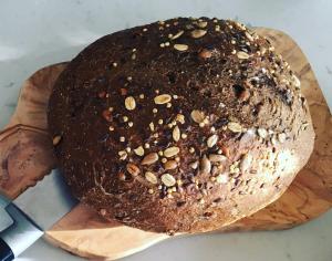 a chocolate bread with nuts on a wooden cutting board at B&B Het Rode Hert in Doesburg