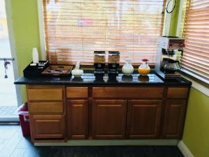 a kitchen counter with vases on top of it at Americas Best Value Inn Visalia in Visalia