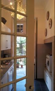 a kitchen with a door leading into a kitchen with a window at Whatever Art B&B in Lisbon