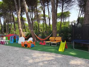 a playground with play equipment and a hammock at Club Vacanze In in Cervia