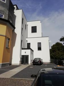 a car parked in front of a white building at Penthousewohnung in Mettmann