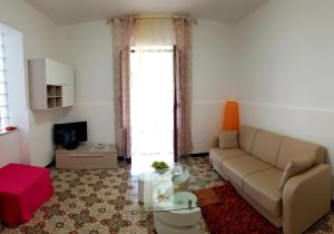 a living room with a couch and a table at Casa Sabrina in Lipari