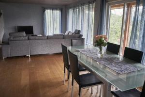 a living room with a table and a couch at Panorama view along the fjord in Stryn in Blakset