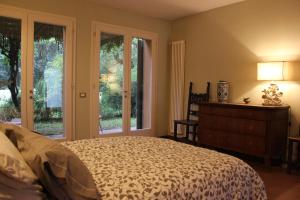 a bedroom with a bed and sliding glass doors at Il Fienile, casa vacanza in campagna con parcheggio privato e giardino privato, a 6 chilometri da Bologna centro e 1 chilometro da Bologna Fiera, Parco commerciale Meraville e Gran Tour Italia in Bologna +24 photos