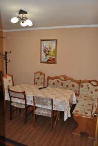 a dining room with a table and chairs at Квітковий двір in Golubinoye