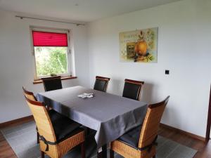a dining room with a table and chairs at Süderdeich in Koldenbüttel