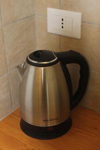 a tea kettle on a counter next to a lightswitch at shelley affittacamere in La Spezia