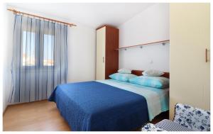 Postel nebo postele na pokoji v ubytování Apartmani Petra