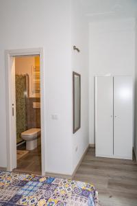 a white bedroom with a bed and a bathroom at shelley affittacamere in La Spezia +15 photos
