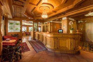 a large room with a bar in a house at Hotel St. Raphael in Madonna di Campiglio