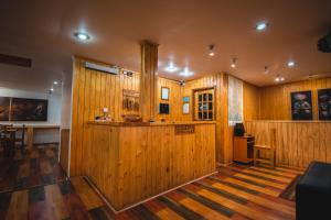 a large room with wooden walls and wooden floors at Hotel Hallef in Puerto Natales