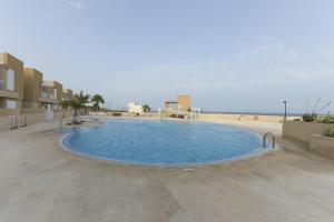 una gran piscina con el océano en el fondo en Apartamento en Residencial cary 2., en Porís de Abona