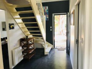 a hallway with stairs and a door to a yard at CosyStudio2 Site du Futuroscope in Jaunay-Marigny