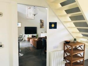 a living room with a staircase leading into a living room at CosyStudio2 Site du Futuroscope in Jaunay-Marigny