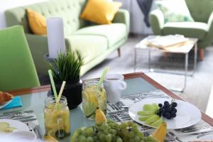 a coffee table with a plate of fruit on it at Dub Apartments Zagreb - free parking in Zagreb