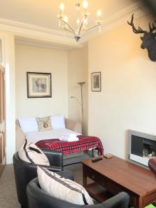 a living room with a couch and a table at Bailie Royal Mile Apartment in Edinburgh