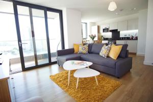 a living room with a couch and a table at London Excel - O2 Arena - London City Airport Superior Apartment in London