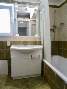 a bathroom with a sink and a shower and a mirror at Camilla City apartment in Larnaca