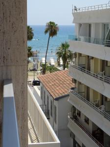 a view of the beach from the balcony of a building at Camilla City apartment in Larnaca