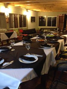 a group of tables with plates and wine glasses at Punta de domos in Punta de Choros