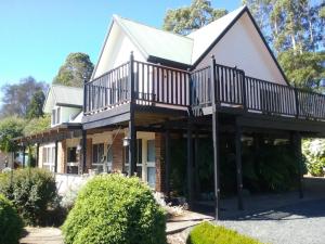 a house with a balcony on the side of it at Robin's Nest B&B in Wilmot