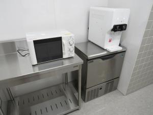 a microwave sitting on top of a counter in a kitchen at Hotel Mirai in Yokohama